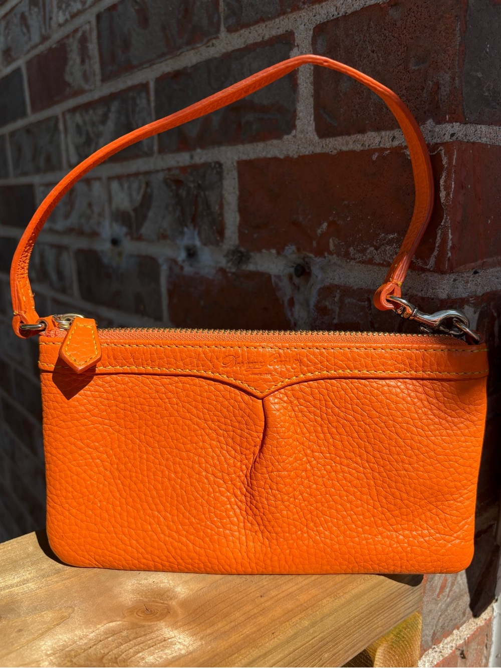 Vintage Dooney & Bourke vibrant orange pebbled leather wristlet